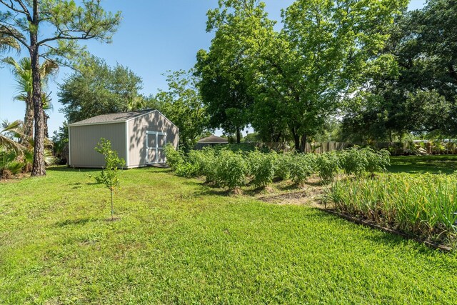 104 Smith Ln, League City, TX 77573 - view of green lawn featuring a storage unit and an outbuilding