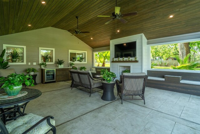 104 Smith Ln, League City, TX 77573 - view of patio with wine cooler, a ceiling fan, an outdoor living space with a fireplace, and fence