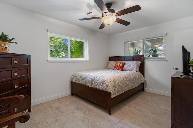 104 Smith Ln, League City, TX 77573 - bedroom with light wood-style flooring, baseboards, and ceiling fan