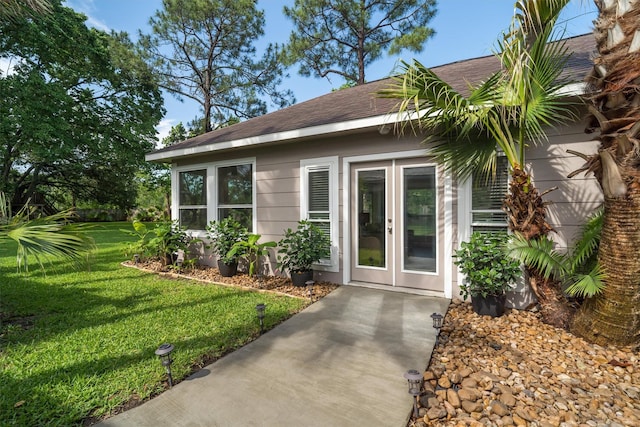 104 Smith Ln, League City, TX 77573 - entrance to property featuring a shingled roof, a lawn, and french doors