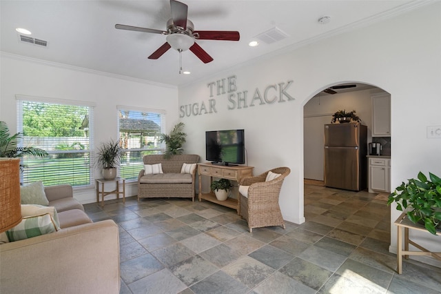 104 Smith Ln, League City, TX 77573 - living room with arched walkways, a ceiling fan, crown molding, stone tile flooring, and recessed lighting