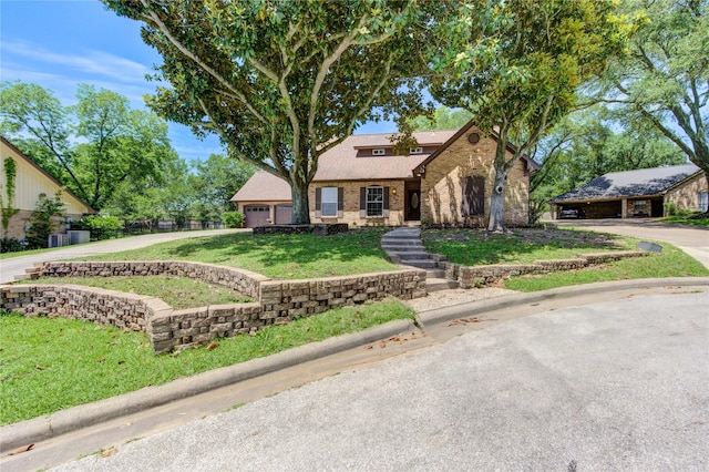 1223 Green Briar Dr, Huntsville, TX 77340 - view of front of home with a front lawn, brick siding, a garage, and driveway