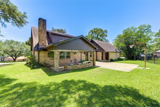 1223 Green Briar Dr, Huntsville, TX 77340 - view of front of property featuring a patio, a chimney, and brick siding