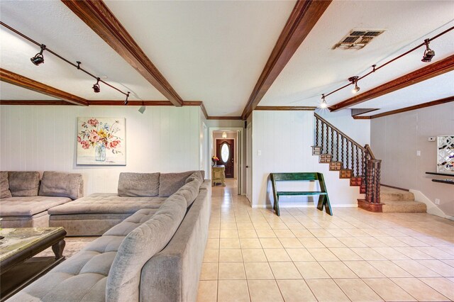 1223 Green Briar Dr, Huntsville, TX 77340 - living area with track lighting, beam ceiling, light tile patterned flooring, stairs, and crown molding
