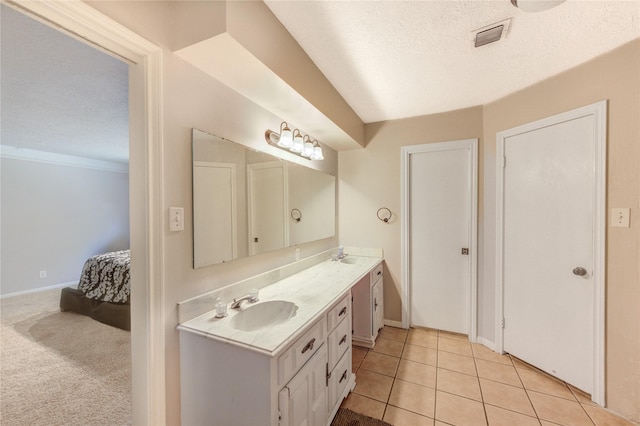 1223 Green Briar Dr, Huntsville, TX 77340 - ensuite bathroom with vanity, a textured ceiling, tile patterned flooring, and baseboards