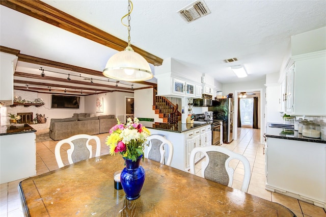 1223 Green Briar Dr, Huntsville, TX 77340 - dining space with light tile patterned floors, stairway, and a textured ceiling