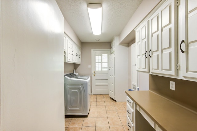 1223 Green Briar Dr, Huntsville, TX 77340 - laundry room with cabinet space, washer and dryer, light tile patterned flooring, and a textured ceiling