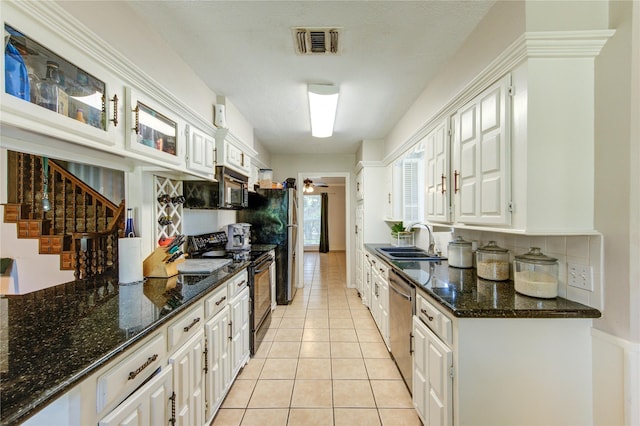 1223 Green Briar Dr, Huntsville, TX 77340 - kitchen featuring black appliances, a sink, white cabinetry, light tile patterned floors, and glass insert cabinets