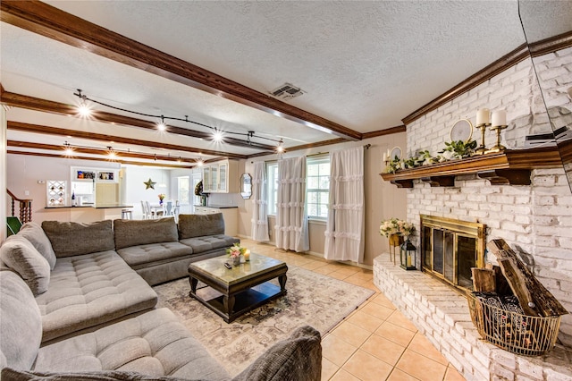 1223 Green Briar Dr, Huntsville, TX 77340 - living area featuring crown molding, light tile patterned floors, a textured ceiling, a brick fireplace, and beamed ceiling