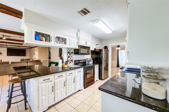 1223 Green Briar Dr, Huntsville, TX 77340 - kitchen featuring black appliances, a peninsula, white cabinets, and light tile patterned flooring
