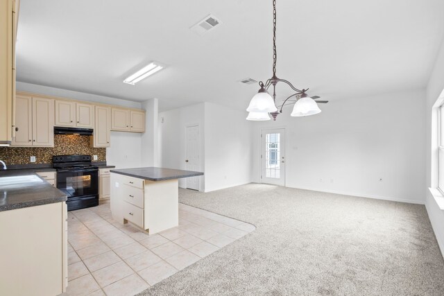 21214 Peachvine Ln, Tomball, TX 77375 - kitchen featuring black electric range oven, cream cabinets, under cabinet range hood, dark countertops, and decorative backsplash