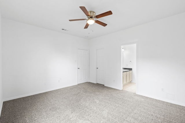 21214 Peachvine Ln, Tomball, TX 77375 - unfurnished bedroom featuring light colored carpet, baseboards, ensuite bathroom, and ceiling fan