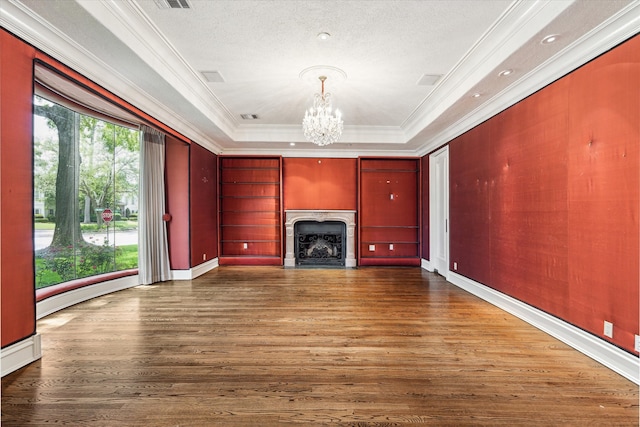 8618 Stable Crest Blvd, Houston, TX 77024 - unfurnished living room with crown molding, a chandelier, wood finished floors, a raised ceiling, and a high end fireplace