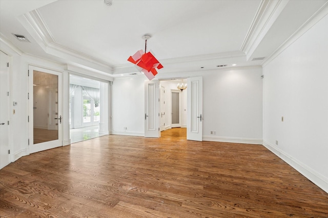 8618 Stable Crest Blvd, Houston, TX 77024 - spare room featuring a chandelier, crown molding, wood finished floors, a raised ceiling, and baseboards