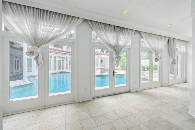 8618 Stable Crest Blvd, Houston, TX 77024 - doorway featuring crown molding, tile patterned flooring, and recessed lighting