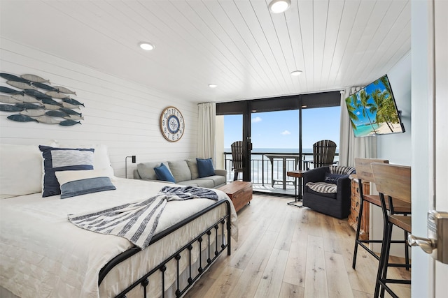 5220 Seawall Blvd Unit 1231, Galveston, TX 77551 - bedroom featuring floor to ceiling windows, access to outside, light wood-style floors, wood walls, and wood ceiling