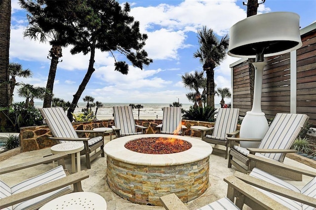 5220 Seawall Blvd Unit 1231, Galveston, TX 77551 - view of patio / terrace featuring a fire pit and a water view