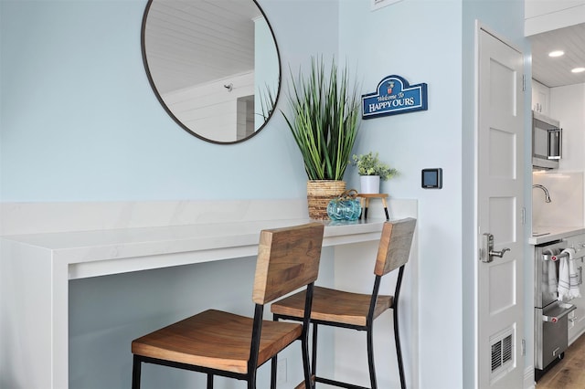 5220 Seawall Blvd Unit 1231, Galveston, TX 77551 - detailed view of stainless steel microwave, wood finished floors, and recessed lighting