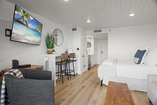 5220 Seawall Blvd Unit 1231, Galveston, TX 77551 - bedroom with light wood finished floors, recessed lighting, and wood ceiling