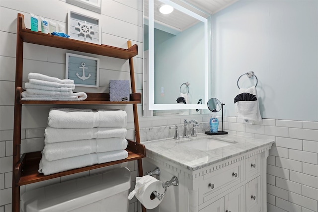 5220 Seawall Blvd Unit 1231, Galveston, TX 77551 - bathroom featuring vanity and tile walls