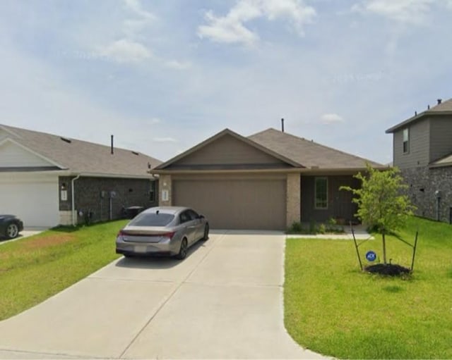 16916 Rich Pines Dr, Conroe, TX 77302 - ranch-style house with concrete driveway, a garage, a front yard, and brick siding