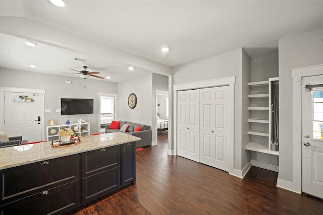 223 Adams St, Houston, TX 77011 - kitchen with light stone countertops, dark wood-style floors, recessed lighting, ceiling fan, and baseboards