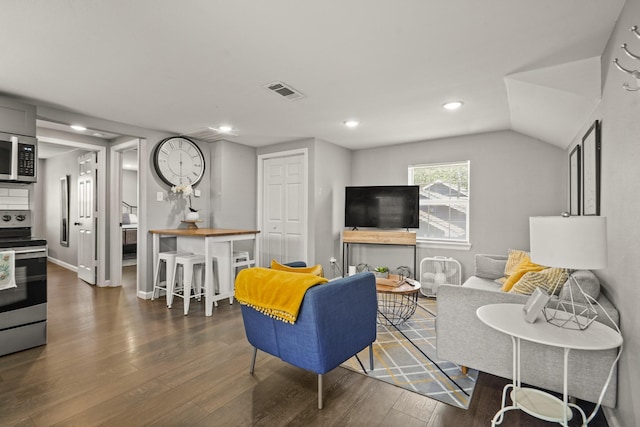 223 Adams St, Houston, TX 77011 - living area featuring wood finished floors, recessed lighting, and vaulted ceiling