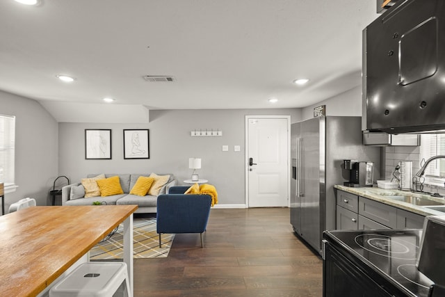 223 Adams St, Houston, TX 77011 - kitchen featuring a sink, black electric range, recessed lighting, dark wood-type flooring, and gray cabinets