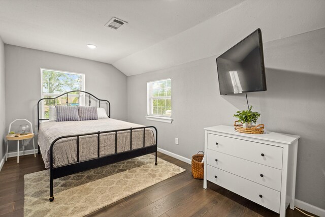 223 Adams St, Houston, TX 77011 - bedroom featuring vaulted ceiling, baseboards, and dark wood-style floors