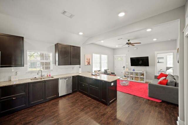 223 Adams St, Houston, TX 77011 - kitchen with dishwasher, a sink, open floor plan, dark wood-style flooring, and a peninsula