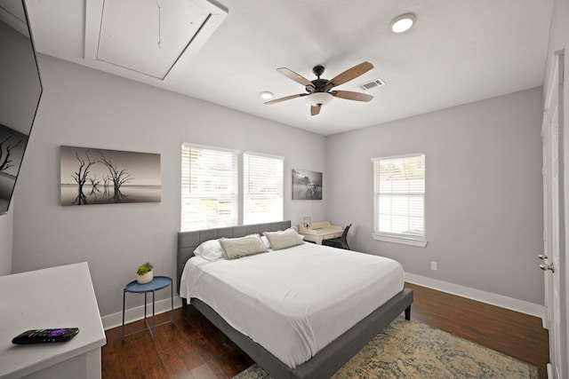 223 Adams St, Houston, TX 77011 - bedroom featuring attic access, baseboards, wood finished floors, and a ceiling fan