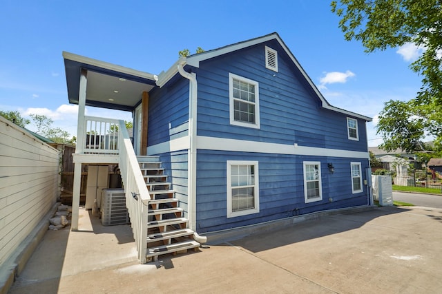 223 Adams St, Houston, TX 77011 - rear view of property with stairs, cooling unit, and fence