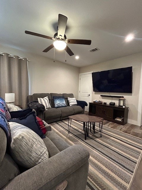 living area featuring wood finished floors, a ceiling fan, recessed lighting, and baseboards