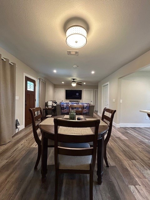 dining room featuring dark wood-style floors, baseboards, a textured ceiling, a ceiling fan, and recessed lighting