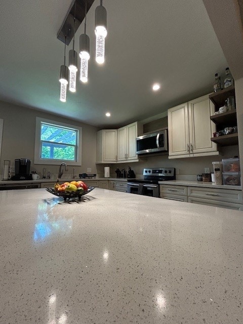 kitchen featuring appliances with stainless steel finishes, open shelves, recessed lighting, white cabinetry, and light stone countertops