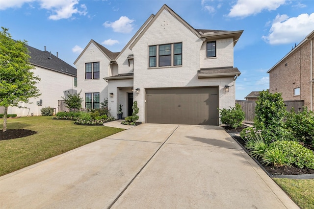 24906 Gingerbush Ln, Tomball, TX 77375 - french country inspired facade with brick siding, a garage, and concrete driveway