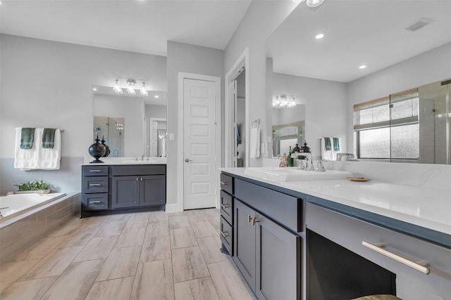 24906 Gingerbush Ln, Tomball, TX 77375 - bathroom with a shower stall, a garden tub, two vanities, and recessed lighting