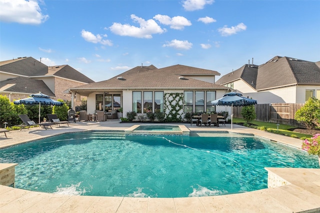 24906 Gingerbush Ln, Tomball, TX 77375 - view of swimming pool featuring a patio area, an outdoor hangout area, fence, and a pool with connected hot tub