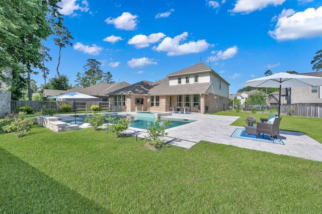 view of swimming pool with a patio and a pool with connected hot tub