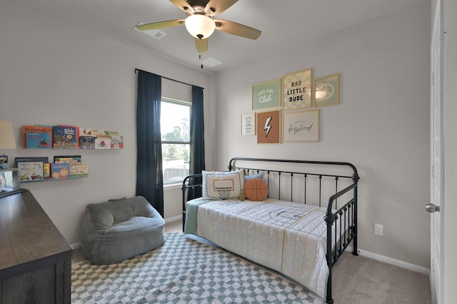 carpeted bedroom featuring baseboards and a ceiling fan