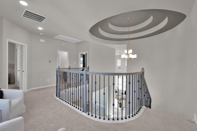 corridor with an upstairs landing, carpet flooring, baseboards, a chandelier, and recessed lighting