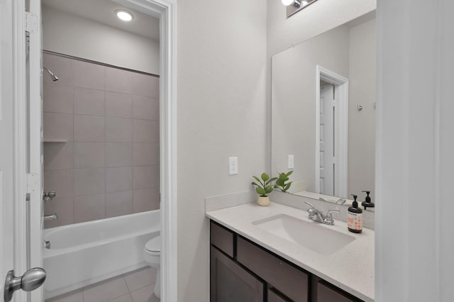 full bathroom featuring toilet, tile patterned floors, vanity, and shower / washtub combination