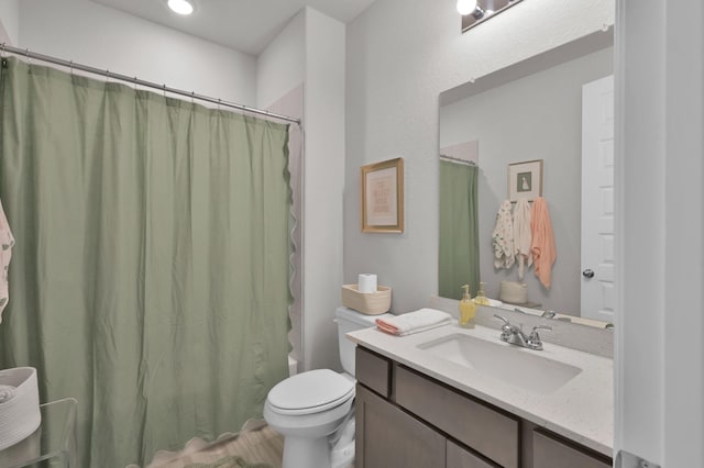 full bathroom with vanity and toilet