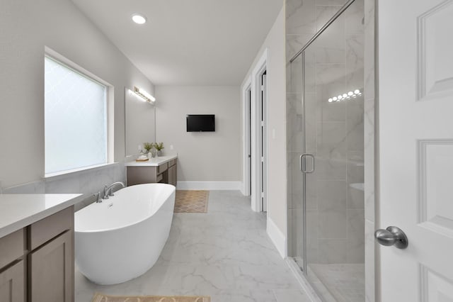 full bath featuring a shower stall, a soaking tub, marble finish flooring, vanity, and recessed lighting