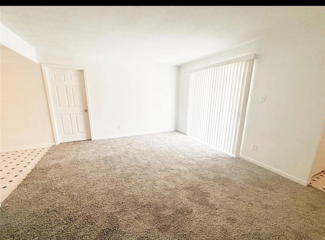 empty room with carpet flooring and baseboards