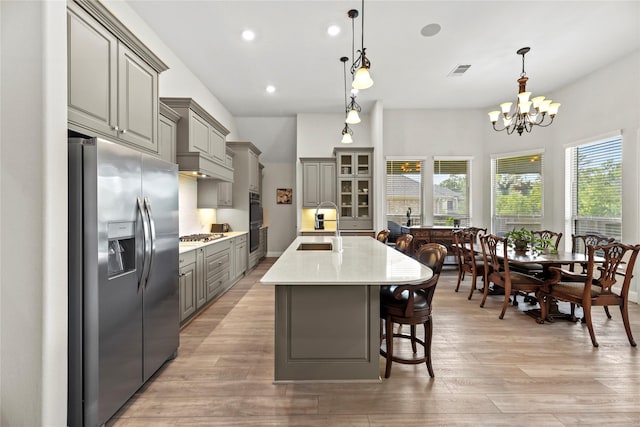 907 Falcon Hollow Ln, Pinehurst, TX 77362 - kitchen featuring stainless steel fridge, gray cabinetry, a sink, healthy amount of natural light, and recessed lighting