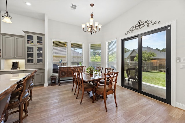 907 Falcon Hollow Ln, Pinehurst, TX 77362 - dining space with a chandelier, healthy amount of natural light, and light wood finished floors