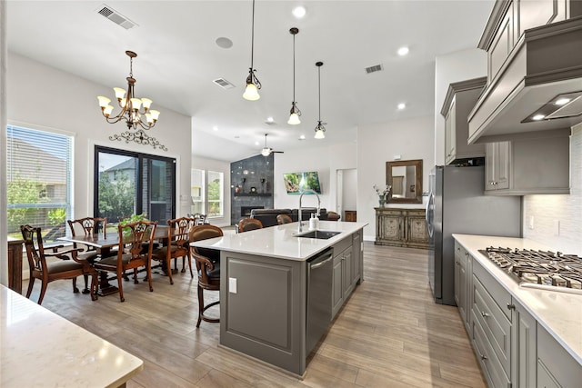907 Falcon Hollow Ln, Pinehurst, TX 77362 - kitchen featuring gray cabinetry, a sink, appliances with stainless steel finishes, light countertops, and recessed lighting