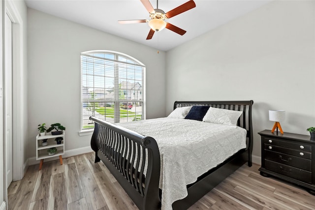 907 Falcon Hollow Ln, Pinehurst, TX 77362 - bedroom with multiple windows, light wood-style flooring, baseboards, and ceiling fan