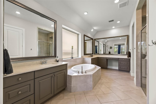 907 Falcon Hollow Ln, Pinehurst, TX 77362 - bathroom featuring a stall shower, a garden tub, recessed lighting, two vanities, and tile patterned flooring